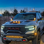 RAM TRX ditch lights on 2019-2024 RAM pickup with dual color white LED and amber DRL backglow, rugged front grille, and off-road lighting