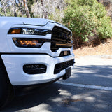 2025+ RAM 2500 light bar slim 40in curved LED light bar mounted on white RAM 2500 front bumper on sunny road