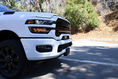 2025+ RAM 2500 light bar slim 40in curved LED light bar mounted on white RAM 2500 front bumper on sunny road