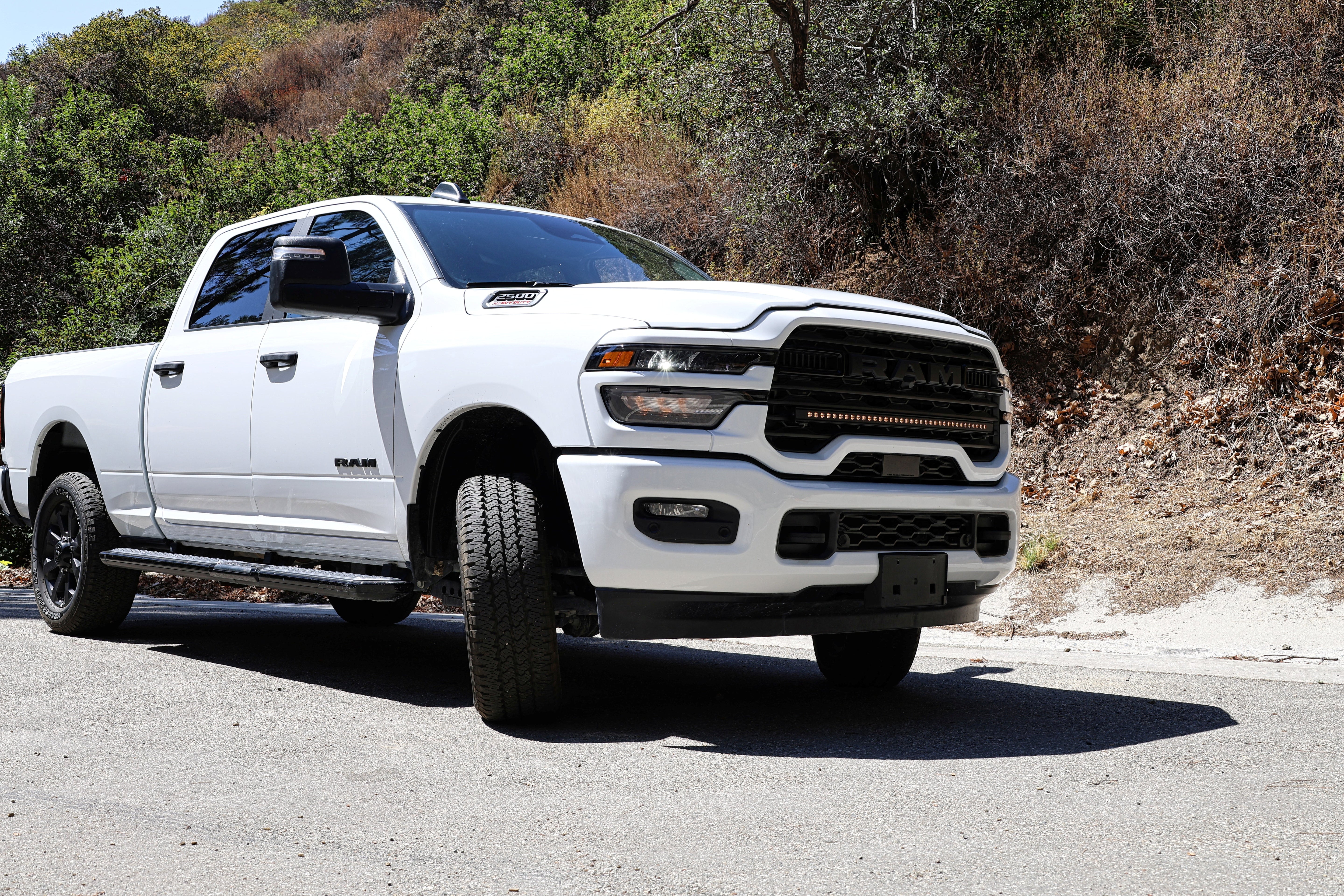 2025+ RAM 2500 light bar slim 40in curved LED installed on white RAM 2500 truck front grille, fits 2025 2026 RAM 2500 3500 trims