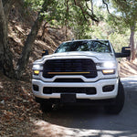 2025+ RAM 2500 light bar 40in slim curved LED installed on white RAM 2500 truck front grille on forest road