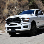 2025+ RAM 2500 light bar slim 40in curved LED installed on white RAM 2500 truck driving on mountain road