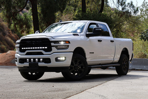 2025+ RAM 2500 Light kit lower grille pods installed on white RAM 2500 truck, bolt-on LED lights, no cutting or drilling