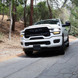2025+ RAM 2500 light bar PRO 40in curved LED installed on white RAM 2500 driving on wooded mountain road
