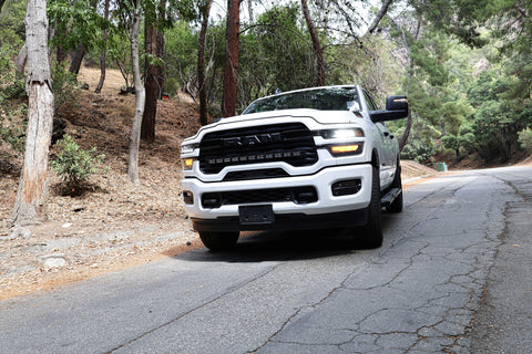2025+ RAM 2500 light bar PRO 40in curved LED installed on white RAM 2500 driving on wooded mountain road