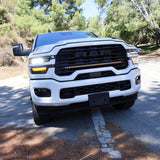 2025+ RAM 2500 light bar 40in slim curved LED grille mount on white RAM 2500 truck front view on forest road