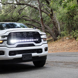 2025+ RAM 2500 light bar PRO 40in curved LED grille mount on white RAM 2500 truck driving on forest road