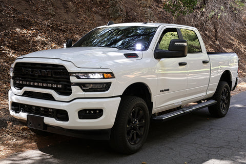 2025+ RAM 2500 & 3500 Ditch Lights installed on white RAM HD truck with dual color white LED and amber DRL backglow