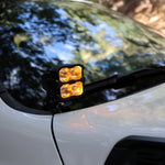 2025+ RAM 2500 & 3500 Ditch Lights PRO dual color amber DRL mounted at windshield cowl on white RAM truck