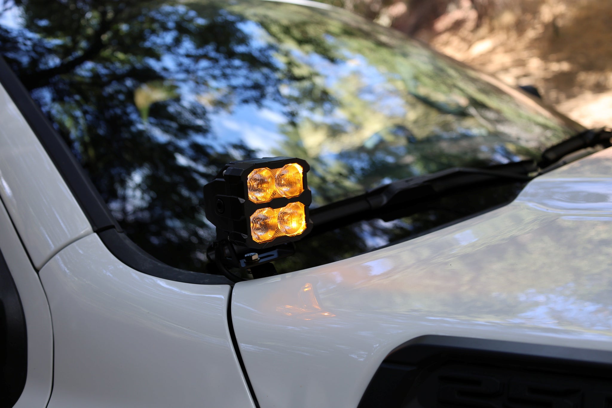 2025+ RAM 2500 & 3500 Ditch Lights PRO dual color amber DRL mounted at windshield cowl on white RAM truck