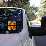 2025+ RAM 2500 & 3500 Ditch Lights dual color amber DRL pods mounted by driver side mirror on white truck