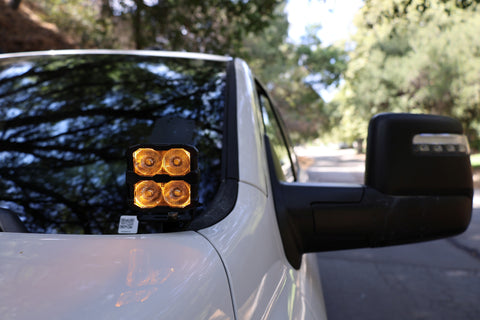 2025+ RAM 2500 & 3500 Ditch Lights dual color amber DRL pods mounted by driver side mirror on white truck