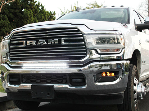 RAM 2500 Fog Light Kit installed on 2025 RAM 2500 truck with slotted fog light bezel and illuminated amber fog lights