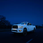 RAM 2500 Fog Light Kit installed on white RAM truck driving at night with bright LED fog lights on highway