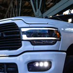 RAM 2500 Fog Light Kit 2025+ installed on white RAM 2500 truck showing bright LED fog lights on front bumper
