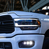 RAM 2500 Fog Light Kit 2025+ installed on white RAM 2500 truck showing bright LED fog lights on front bumper