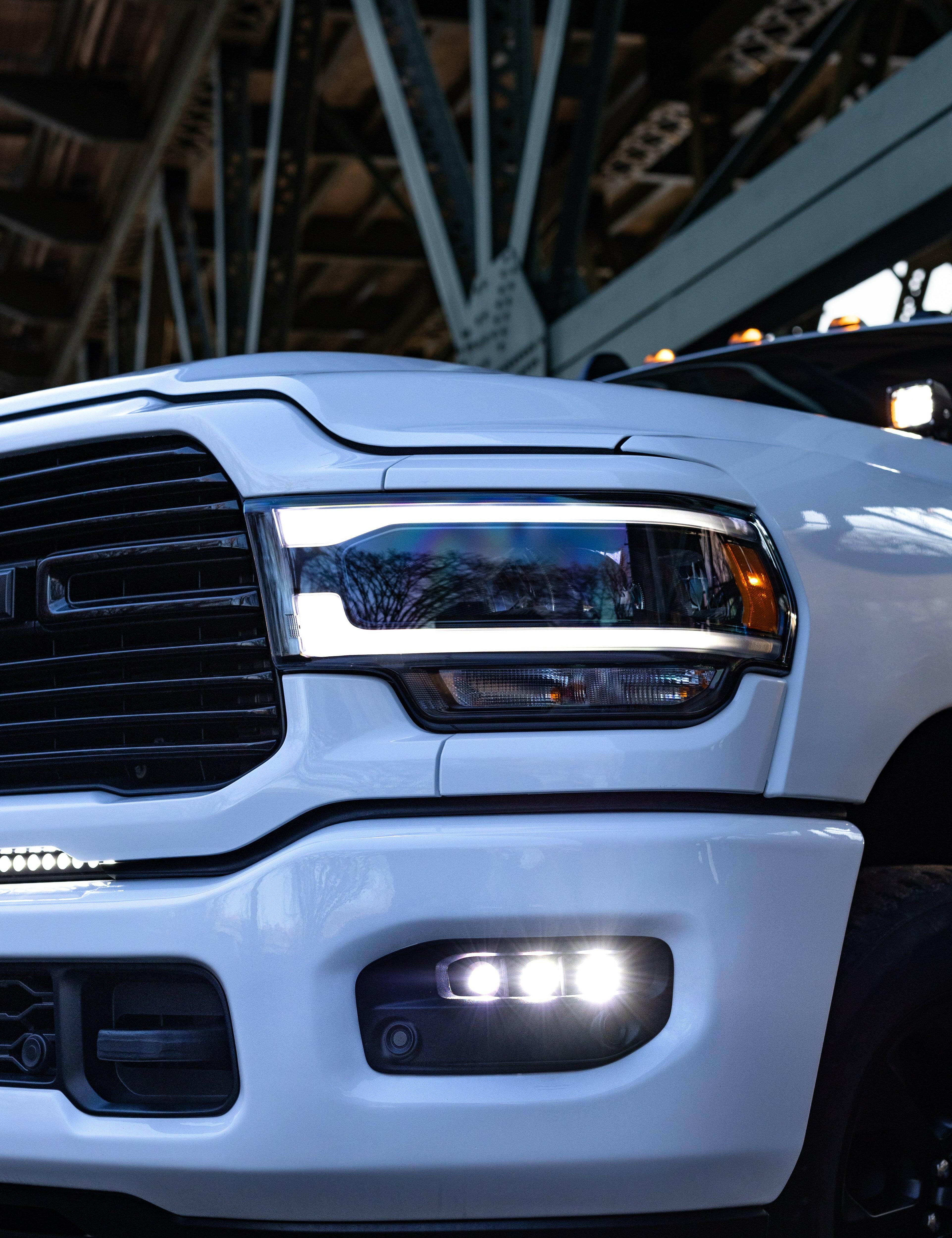 RAM 2500 Fog Light Kit 2025+ installed on white RAM 2500 truck showing bright LED fog lights on front bumper