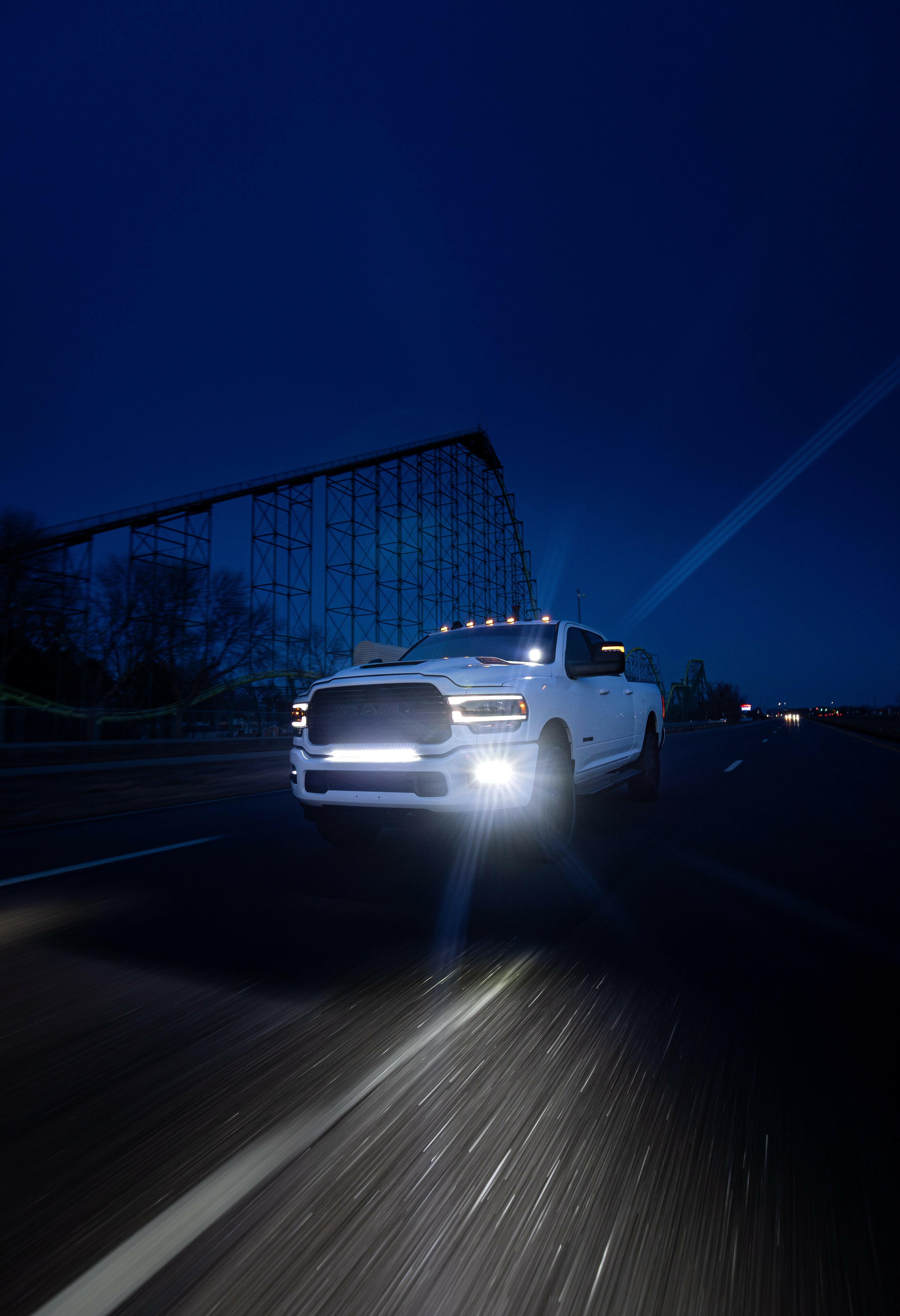 RAM 2500 Fog Light Kit installed on white truck driving at night with bright LED fog lights on highway