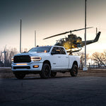 RAM 2500 Fog Light Kit installed on white RAM 2500 truck parked at dusk with helicopter in background