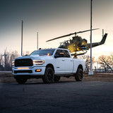 RAM 2500 Fog Light Kit installed on white RAM 2500 truck parked at dusk with helicopter in background