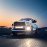 RAM 2500 Fog Light Kit installed on white RAM 2500 truck driving at dusk with bright LED fog lights on highway