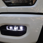 RAM 2500 Fog Light Kit installed on white RAM 2500 front bumper with bright LED fog lights illuminated