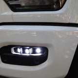 RAM 2500 Fog Light Kit installed on white RAM 2500 front bumper with bright LED fog lights illuminated