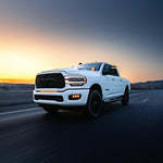 RAM 2500 Fog Light Kit installed on white RAM 2500 truck driving at sunset on open highway
