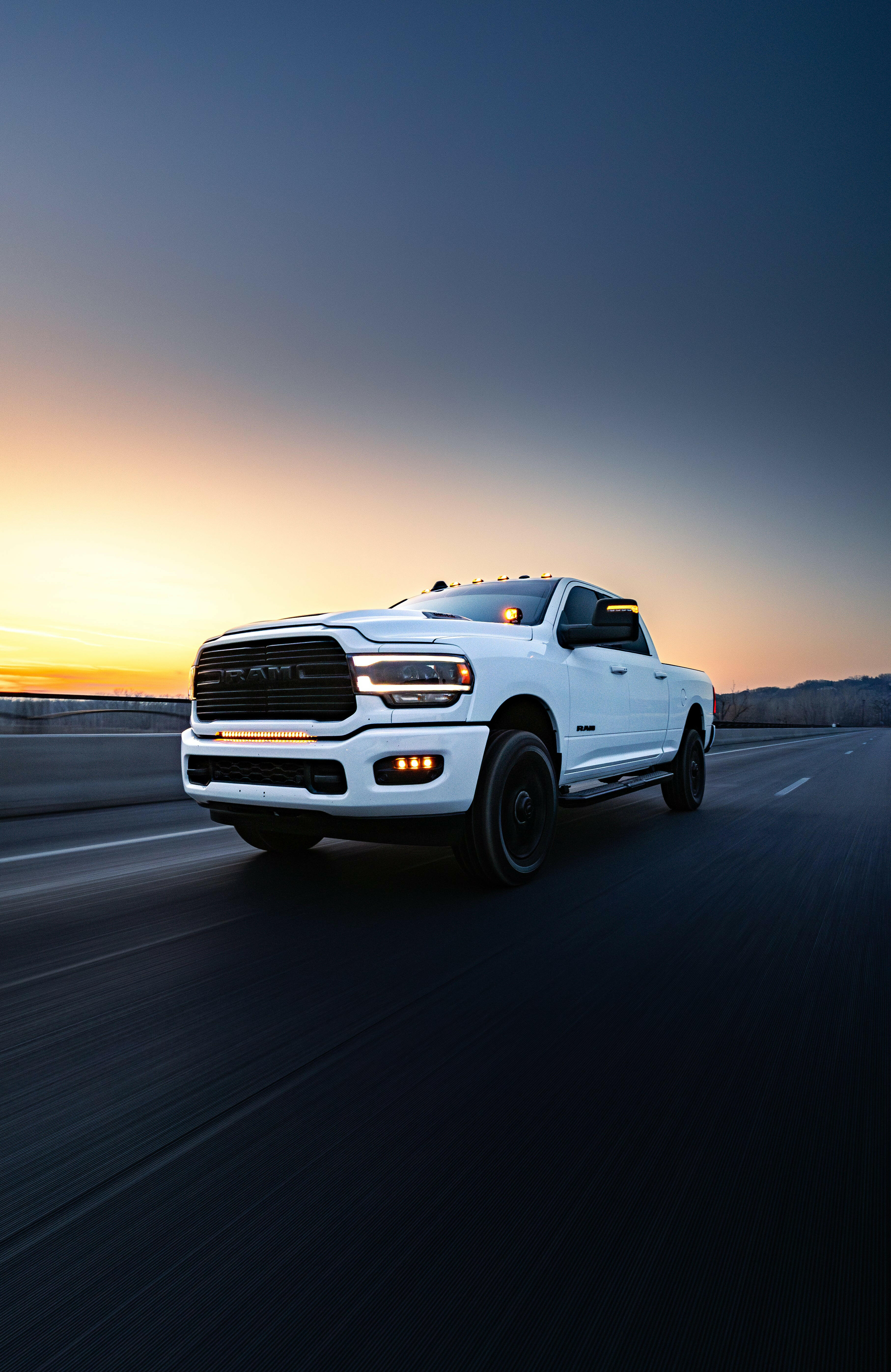RAM 2500 Fog Light Kit installed on white RAM 2500 truck driving at sunset on open highway