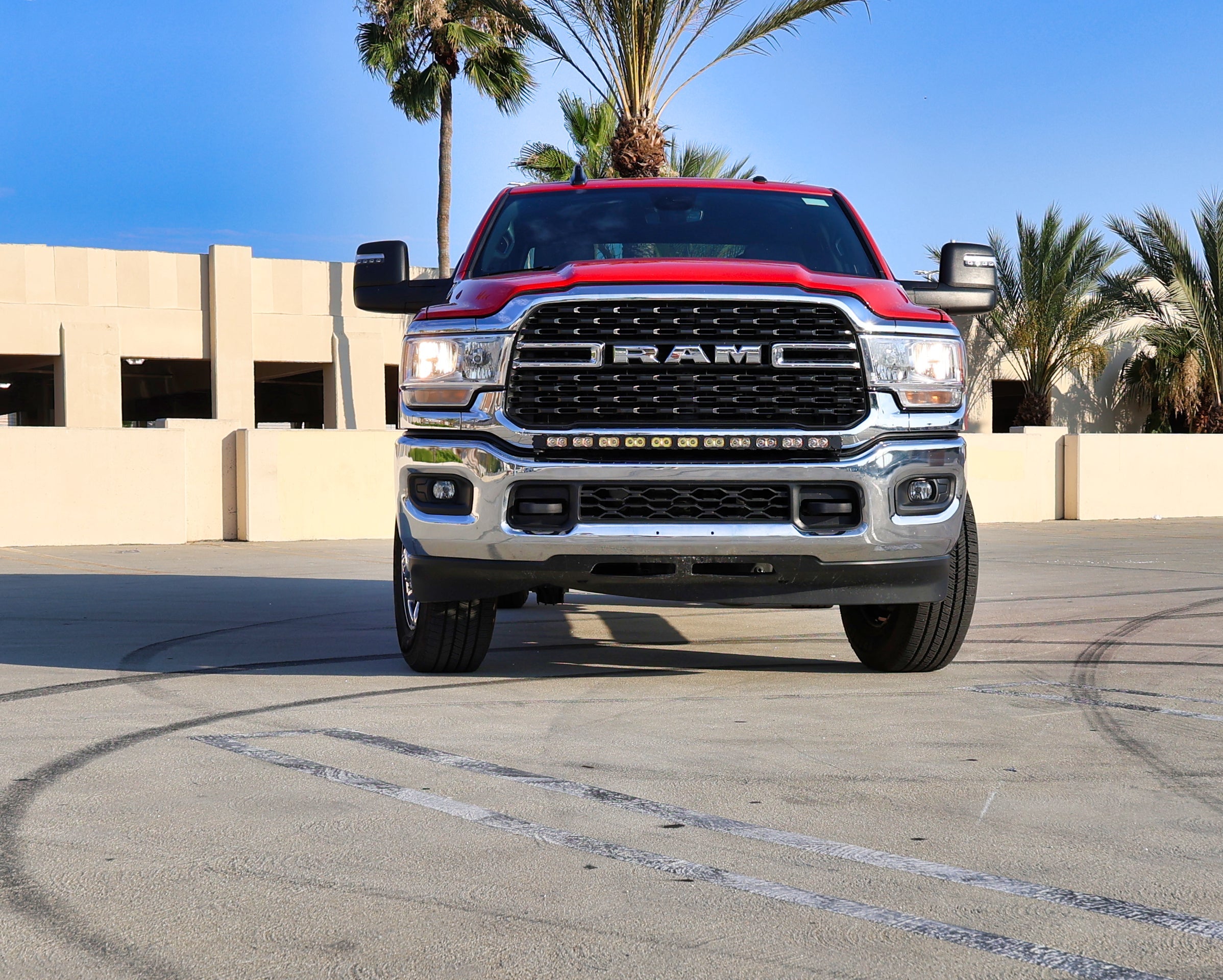RAM 2500 3500 HD 40in Light Bar PRO installed on red RAM HD truck front view in sunny parking lot