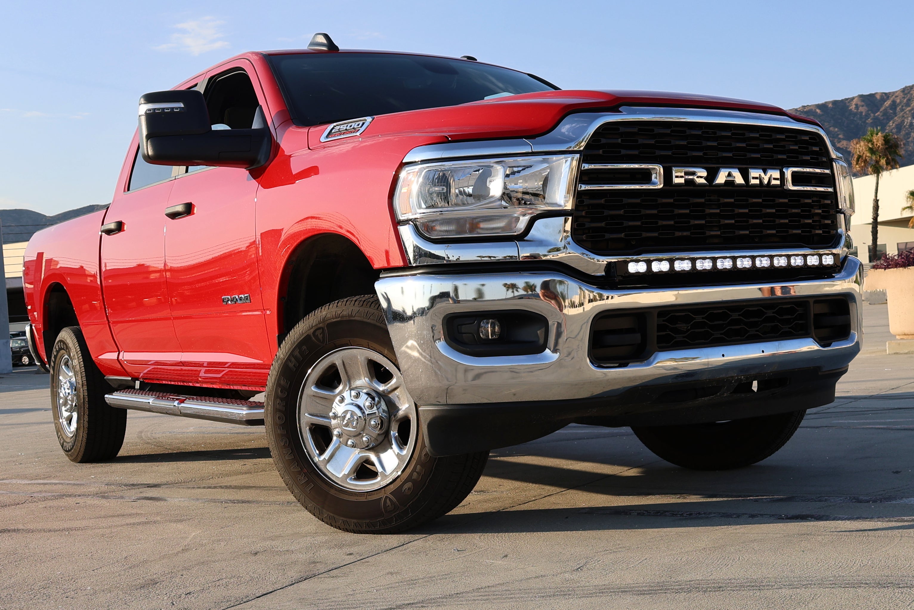 Red RAM truck front view showcasing RAM 2500 3500 HD 40in Light Bar curved LED PRO mounted in front bumper