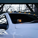 2025+ RAM 2500 3500 Ditch Lights with dual color amber DRL mounted on white truck cowl for improved off-road visibility