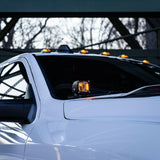 2025+ RAM 2500 3500 Ditch Lights with dual color amber DRL mounted on white truck cowl for improved off-road visibility