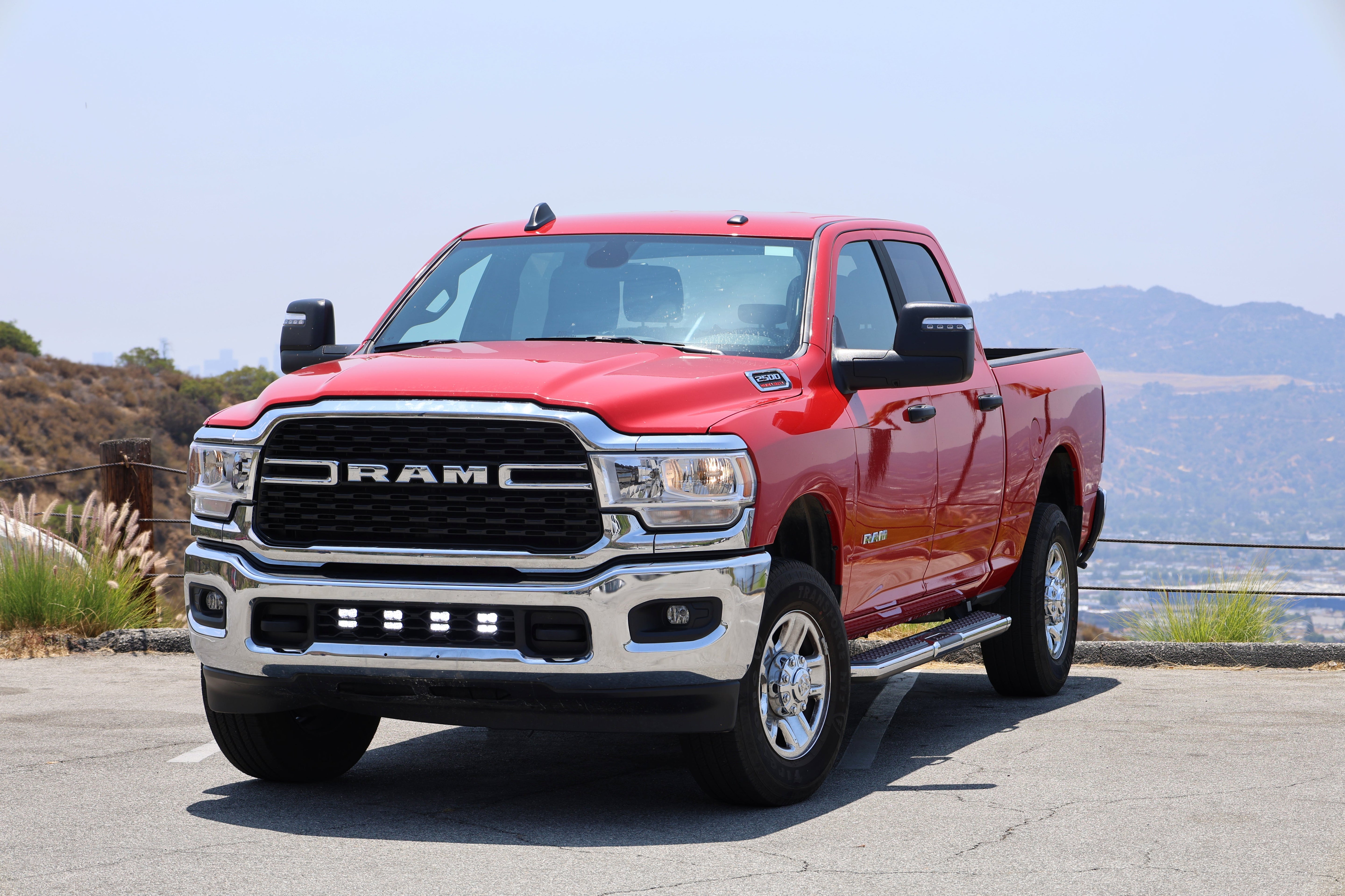RAM 2500 lightbar Bumper Light kit installed on red 2019-2024 RAM 2500 truck with lower grille LED light pods