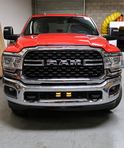 RAM 2500 lightbar Bumper Light kit installed in lower grille on red RAM 2500 truck front view