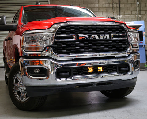 RAM 2500 lightbar Bumper Light kit installed on 2019-2024 RAM 2500 lower grille with LED light pods illuminated