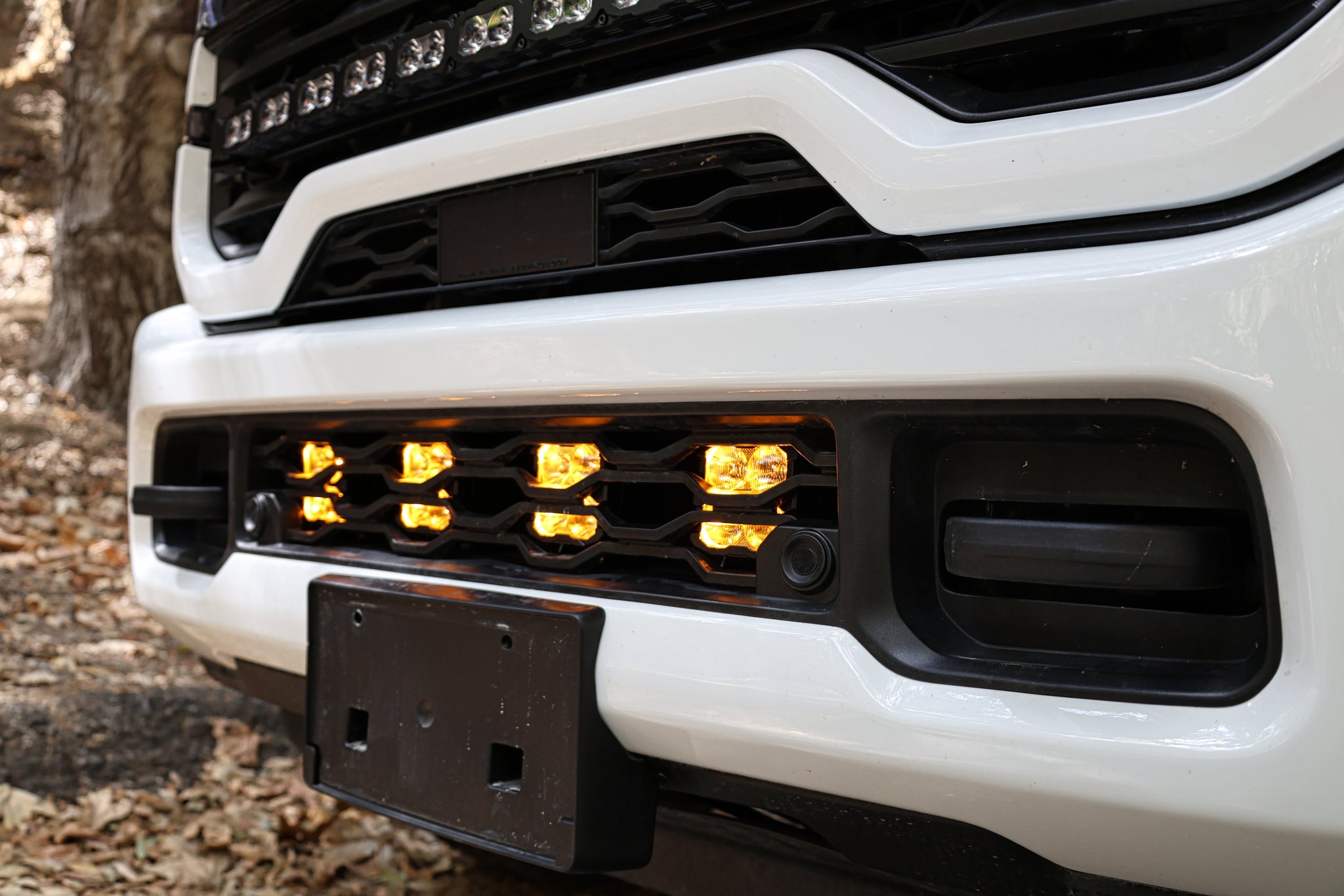 2025+ RAM 2500 Light kit lower grille pods with amber LED lights installed, no-cut bolt-on truck lighting upgrade