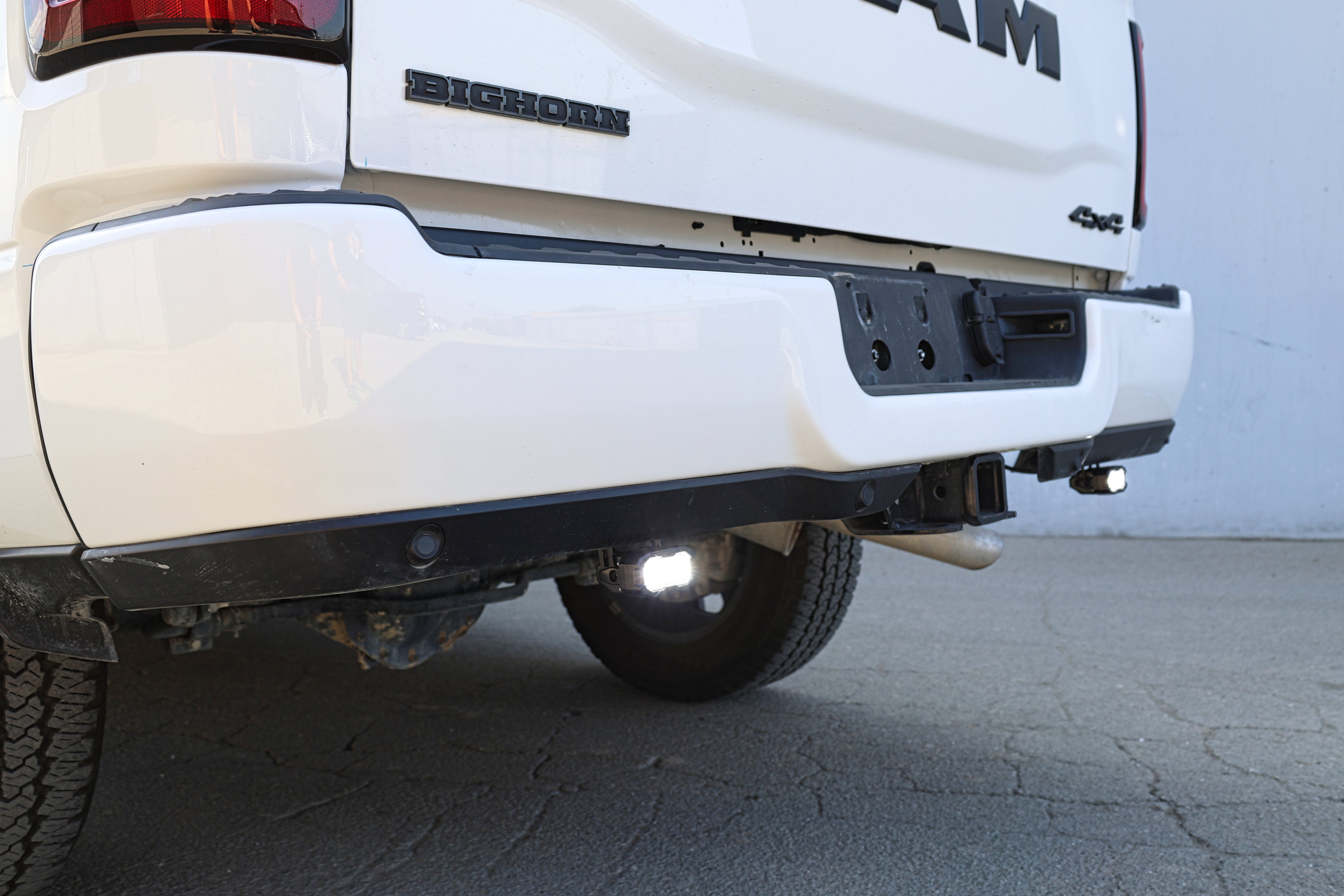 RAM 2500 Reverse Light Kit installed under rear bumper, bright white LED pods illuminating behind 2025 RAM 2500 truck