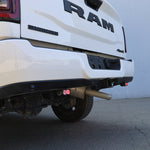 RAM 2500 Reverse Light Kit installed on rear bumper showing illuminated pod on white RAM 2500 truck