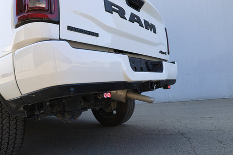 RAM 2500 Reverse Light Kit installed on rear bumper showing illuminated pod on white RAM 2500 truck