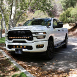 RAM 2500 Fog Light Kit installed on white RAM 2500 truck parked outdoors showcasing upgraded front bumper fog lights