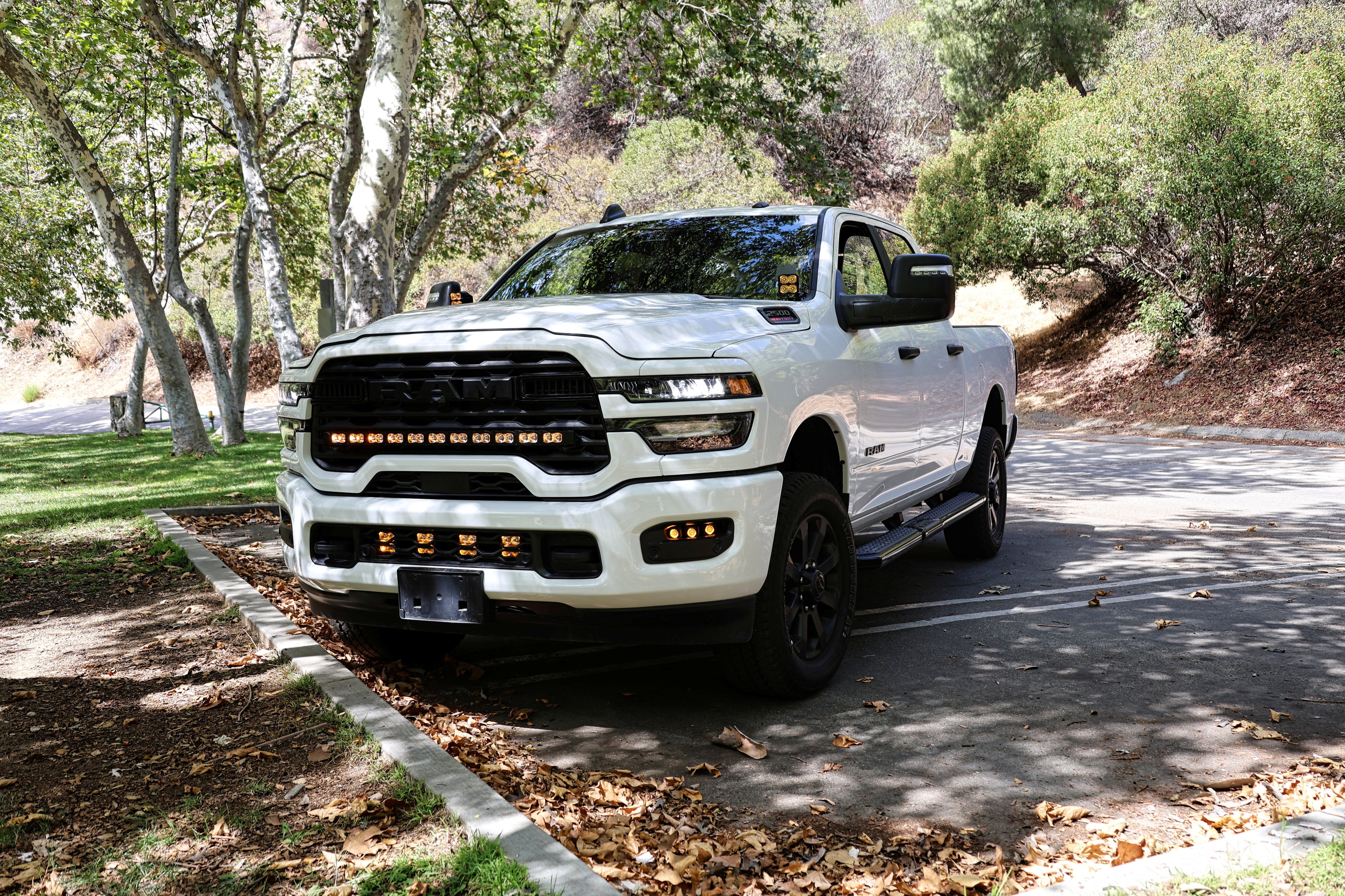 RAM 2500 Fog Light Kit installed on white RAM 2500 truck parked outdoors showcasing upgraded front bumper fog lights