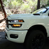 2025+ RAM 2500 light bar slim curved LED on white RAM 2500 truck front driver side in wooded road setting