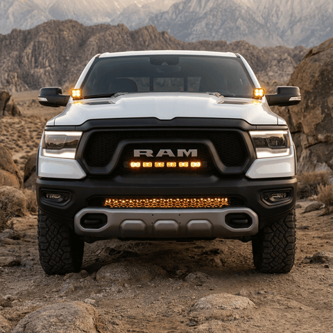 RAM REBEL light bar PRO installed on white RAM 1500 Rebel in rocky off-road terrain, curved LED light bar between grille and bumper