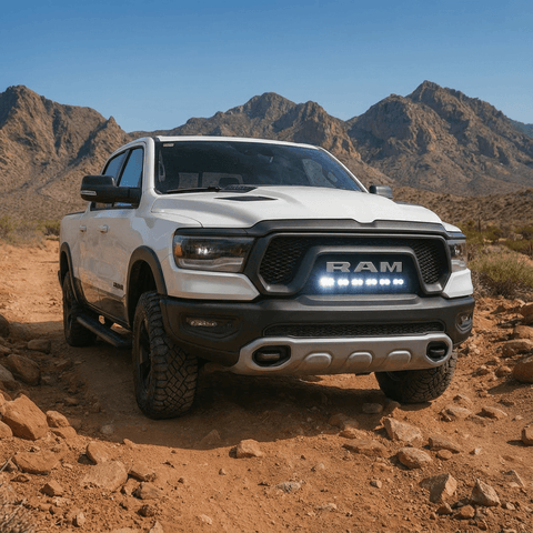 RAM REBEL light bar PRO installed on white RAM 1500 Rebel driving off-road in desert mountains