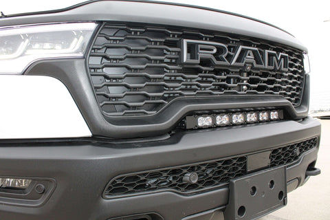 RAM RHO light bar PRO 23in curved LED mounted between grille and bumper on 2025 RAM 1500 RHO Rebel front view