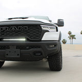 RAM RHO lightbar on 2025+ RAM 1500 Rebel between grille and bumper; slim curved light bar with black powder-coated bracket, 23in length