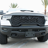 RAM RHO lightbar on 2025+ RAM 1500 Rebel — curved slim light bar between grille and bumper with black powder-coated bracket; RAM RHO lightbar