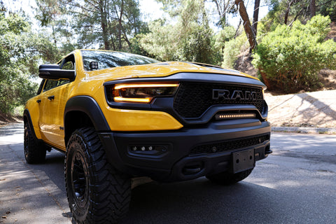 RAM TRX Light bar slim 23in installed in factory grille opening on yellow 2021-2024 RAM 1500 TRX front view