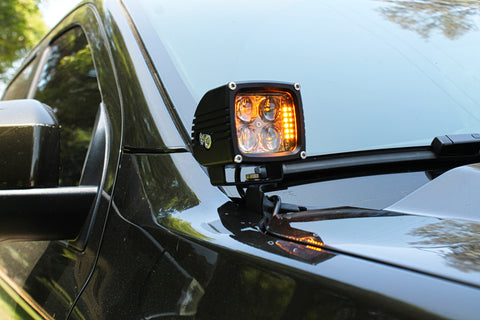 2024 Ford Ranger Raptor hood mount LED lights with amber backglow installed on a black vehicle.